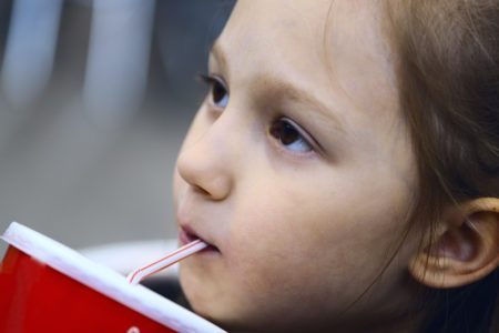 soda girl drinking sugary drink kid's meal