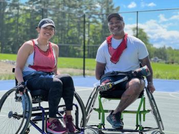 woman and man in wheelchairs on basketball court