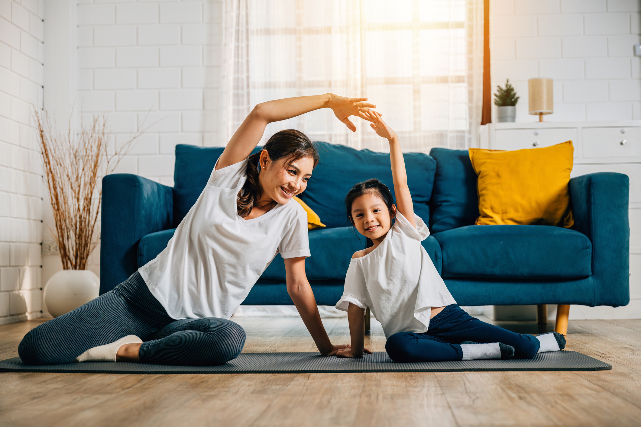 Mom and daughter doing yoga