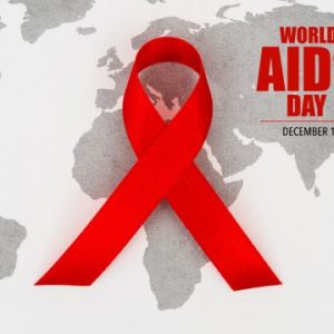 A red awareness ribbon over a world map, symbolizing World AIDS Day and global HIV awareness and prevention efforts.